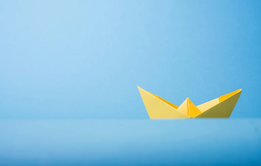 Closeup photo of yellow paper boat
