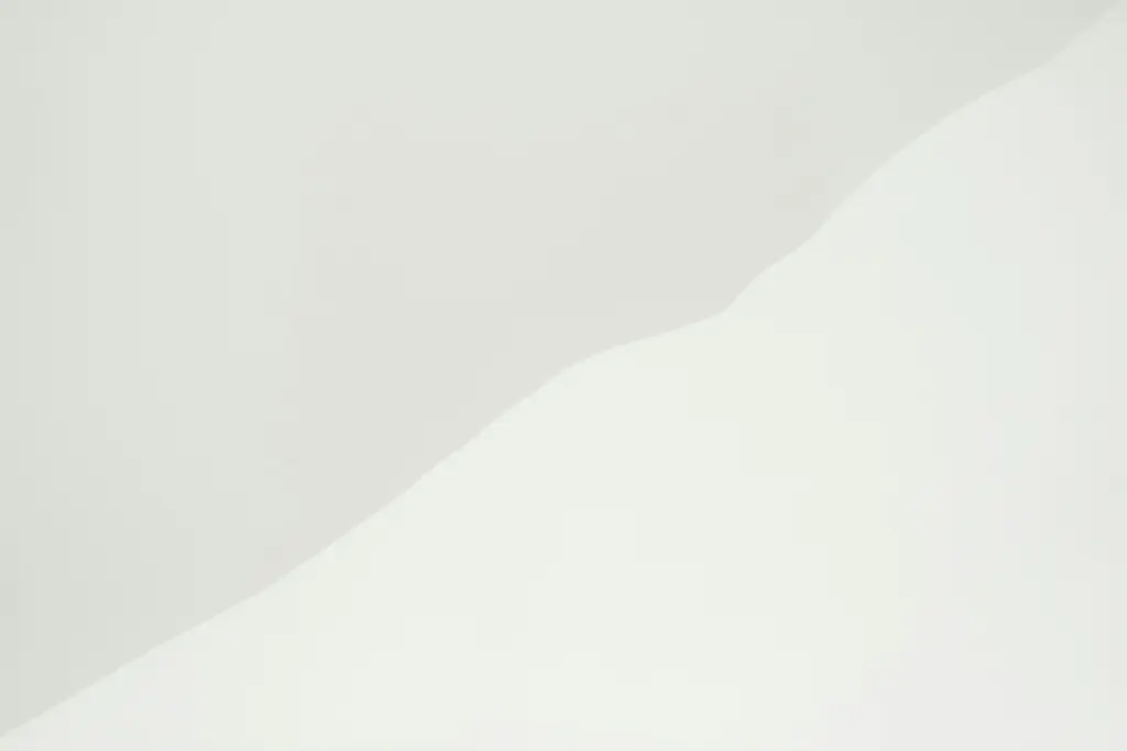 Man riding a snowboard down the side of a snow covered slope